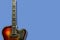 Old, jazz electric guitar on a blue background. Copy space. Background for music festivals, concerts.Musical education. Concert