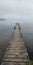 Old jetty on a still calm lake, plenty of fog covering the shores