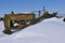 Old John Deere tractor buried in the snow