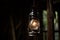 Old kerosene lamp hanging on a wooden wall in the dark Ai generative