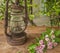Old kerosene lamp and twig with pink flowers