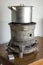 Old kerosene stove with a saucepan stands on the table beside ma