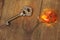 Old key and a magic amber keychain lies on an old wooden table, natural textures, a concept of discovery, secrets, answers,