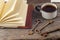 Old keys, book, cake with cup of tea on rustic wooden background.