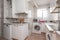 Old kitchen with mismatched white furniture with conventional aluminum windows