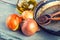 Old kitchen pan wooden spoon three onions carafe with olive oil on wooden table.