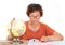 An old lady with a Chinese face in front of a white background indoors is studying the globe and map on the table