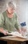 An old lady making little pies. Knead the dough. Portrait