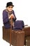 The old lady sits on a suitcase