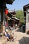An old lady takes a nap on the cobblestone streets of Lijiang Old Town