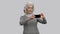 Old lady taking vertical and horizontal selfie photos on her frontal camera.