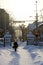 Old lady walking in newly fallen snow in the city