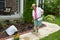 Old lady at work in the garden cleaning flowerbeds