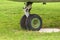 Old landing gear of an old airplane close-up on a background of green grass
