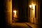 Old lanterns illuminating a dark alleyway medieval street at night in Prague, Czech Republic.