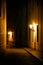 Old lanterns illuminating a dark alleyway medieval street at night in Prague, Czech Republic. Low key photo with brown yellow tone