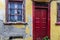 Old latticed window and a red door in Athens, Greece