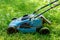 Old lawnmower on green grass in the park