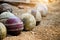 Old leather cricket balls on sand