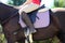 Old leather saddle with stirrups for show jumping race