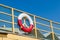 Old lifebuoy attached to the railing on the rescue post