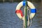 The old lifebuoy hanging beside pond in public park