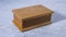 Old light brown wooden carved  jewelry box on a gray background.