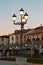 Old lighted lanterns on the background of beautiful buildings and trees