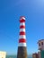 Old lighthouse on the firmament of a blue sky