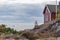 Old lighthouse, house and boat entering the sea gate in the Baltic Sea, selective focus