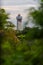 The old lighthouse of Puducherry, South India seen through a group of trees