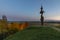 Old Lithuanian traditional wooden cross on a hill