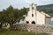 Old little chapel in an olive grove by the sea