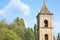 Old little italian Romanesque church in the Tuscany countryside with brick built bell tower against woodland - Tuscany- Italy