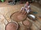 An old local woman sits on the floor and sorts peanuts in a village workshop