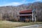 An old log cabin sitting amidst winter`s desolate landscape, southeastern Tennessee