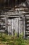 An old log cabin with a weathered rickety door