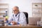 Old male doctor pharmacist in drugs synthesis concept