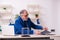 Old male employee businessman and meditation balls on the desk