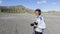 Old male photographer standing at Mount Bromo