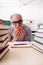 Old male student eating apple during exam preparation