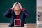 Old male teacher physicist sitting in the classroom