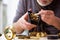 Old male watchmaker working in the workshop