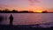 Old Man admiring sunrise on the beach. Beautiful fiery sunset.