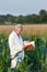 Old man agronomist in corn field