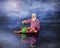 Old man on beach with bucket and green bag