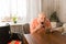 Old Man Cleaning his Beard with Razor at the Table