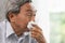 Old man elder get sick wipe the nose snot from flu and runny nose