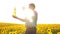 Old man farmer sunflower oil concept agriculture. old man farmer holding in hand a plastic bottle sunflower oil stands