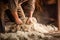 Old man gathers sheared sheep wool from ground on farm yard woven material producing